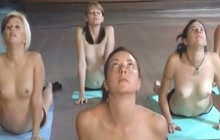 Room full of naked women doing yoga